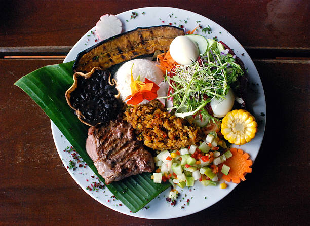 Costa Rican food traditional plate in Costa Rica, called "Casado". It's composed by rice, beans, steak, banana egg, corn and salad. costa rica food stock pictures, royalty-free photos & images
