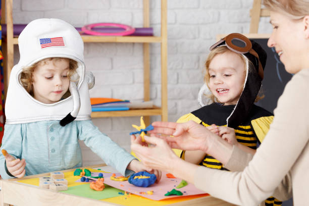 Costume party in kindergarten Little boy and girl dressed up on costume party in kindergarten classroom party stock pictures, royalty-free photos & images