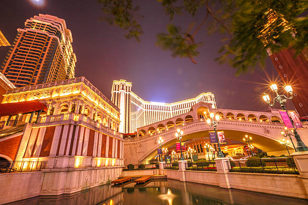 Cotai shopping centre Macau, China - December 8, 2016: Cotai Strip illuminated at night: tower, bridge, shopping center, canal, lake, The Venetian and Four Seasons Hotel. Macau is famous for luxury shopping and Casino. the venetian macao stock pictures, royalty-free photos & images