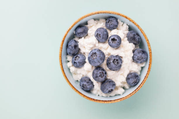 Cottage cheese with blueberry, fresh berries, keto healthy breakfast concept, top view. stock photo