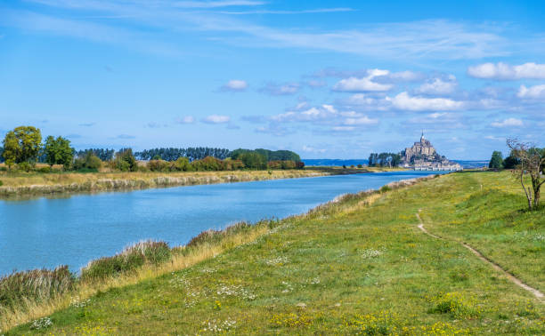 Couesnon River leads to Mont St. Michel in Normandy, France Mont Saint Michel, France - August 29, 2019: River Couenon leads to Mont Saint Michel in Lower Normandy, France manche stock pictures, royalty-free photos & images