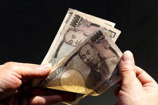 Counting JPY(Japanese Yen) 10,000 banknotes Counting JPY(Japanese Yen) 10,000 banknotes BANK OF JAPAN  stock pictures, royalty-free photos & images