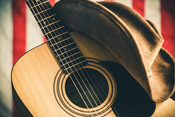 Country and western music Acoustic Guitar and Cowboy Hat with American Flag on Background country and western music stock pictures, royalty-free photos & images