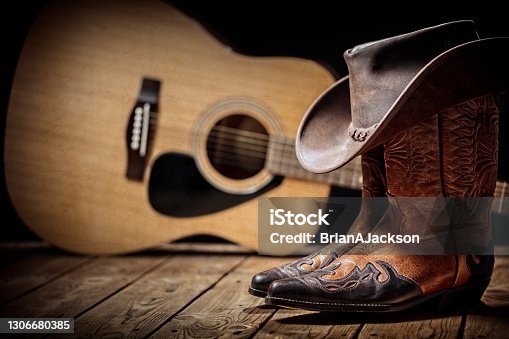 istock Country music festival live concert with acoustic guitar, cowboy hat and boots 1306680385