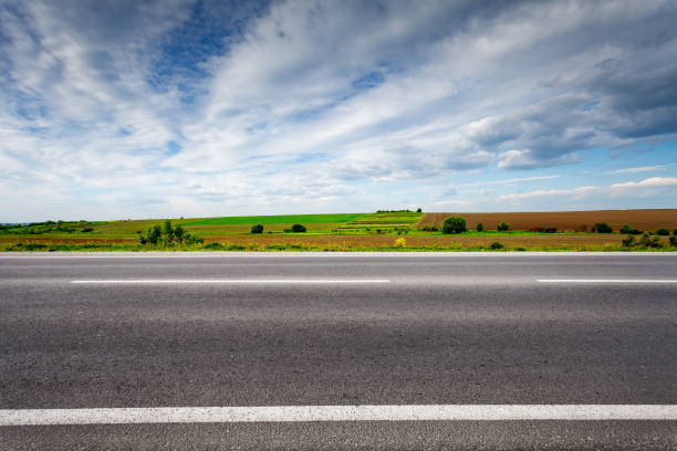 Country road with field on horizon, side view. stock photo