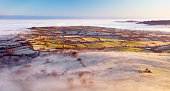 Rolling countryside in early morning mist in Wales, UK
