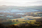 Rolling countryside in early morning mist in Wales, UK