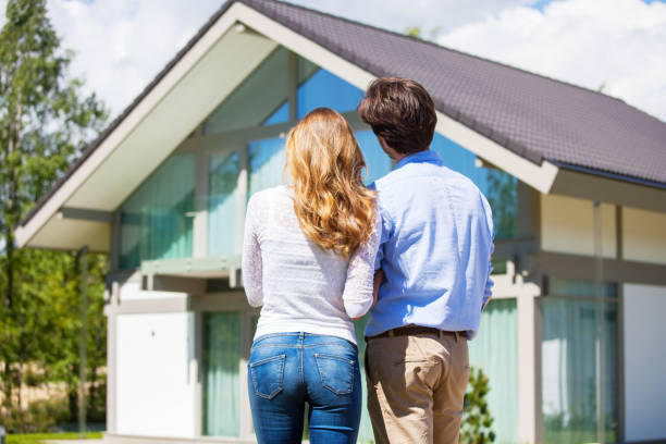 Couple and their house stock photo