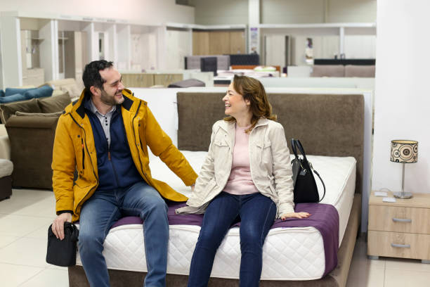Couple buying a bed stock photo