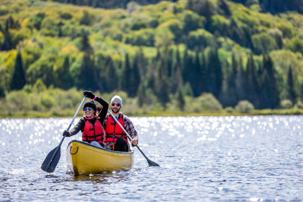 Couple Canoeing at Parc National du Mont-Tremblant, Quebec, Canada stock photo