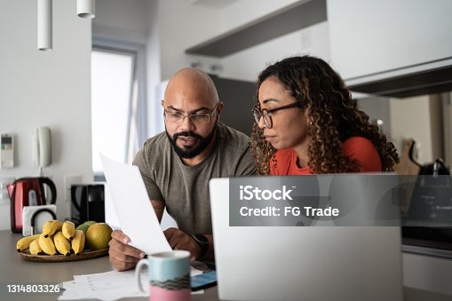 istock Couple doing home finances together at home 1314803326
