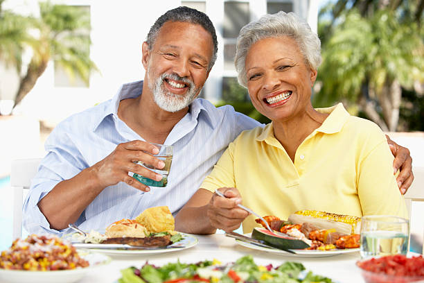 Couple Eating Al Fresco  old black couple in love stock pictures, royalty-free photos & images
