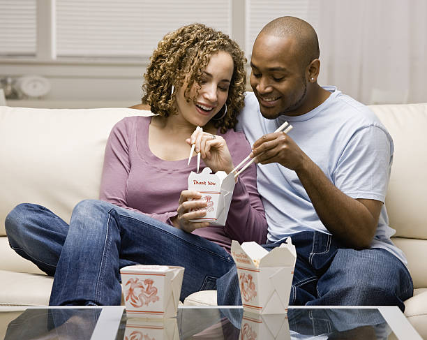 Couple eating take-out Chinese food stock photo