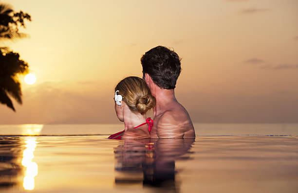 Couple embracing in infinity pool