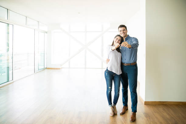 Couple Feeling Happy About Buying New House Full length of mid adult couple feeling happy about buying a new house mid adult couple stock pictures, royalty-free photos & images