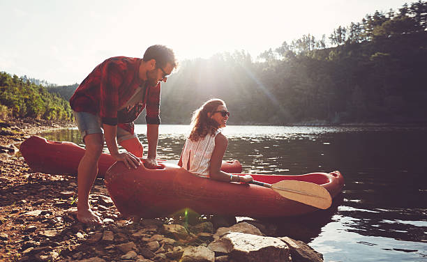 couple going for kayaking in lake - kano stockfoto's en -beelden