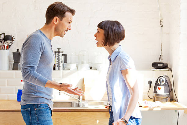 Couple having a discussion in the kitchen stock photo