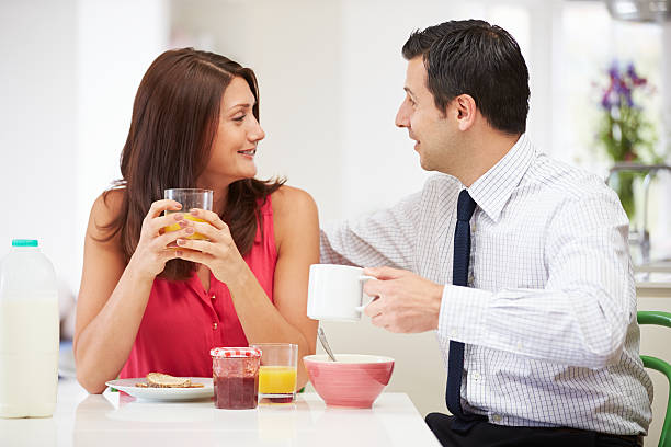 Happy Smiling Couple Having Breakfast Before Husband Goes To Work