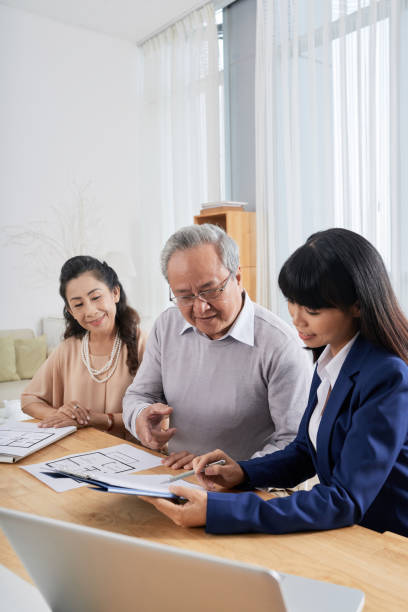 Couple Having Meeting with Real Estate Broker stock photo