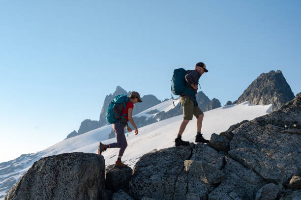 Couple hiking in the mountains stock photo