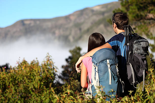 Couple hiking looking at view Couple hiking looking at view during hike in forest on Tenerife, Canary Islands, Spain. Click for more: eco tourism stock pictures, royalty-free photos & images