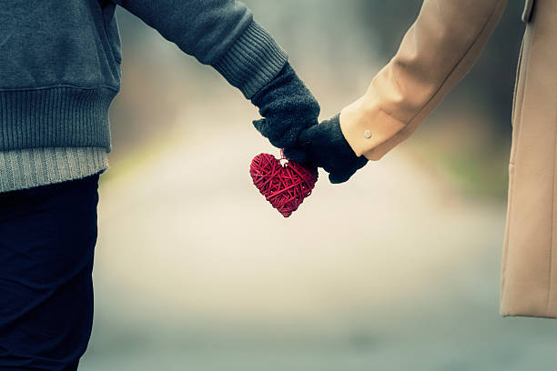 Couple in love holding hearts. stock photo