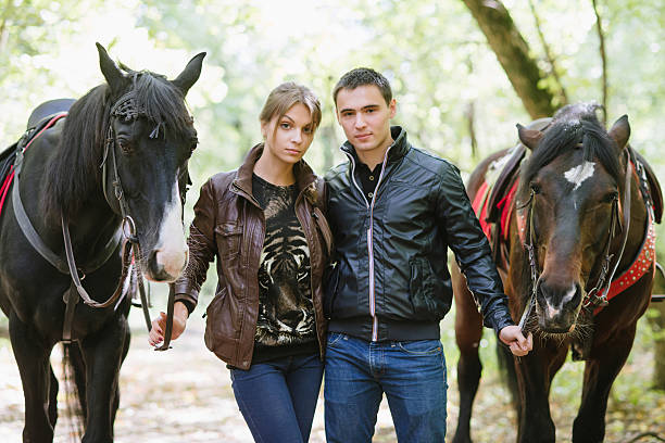 couple in love, horseback riding, summer forest stock photo