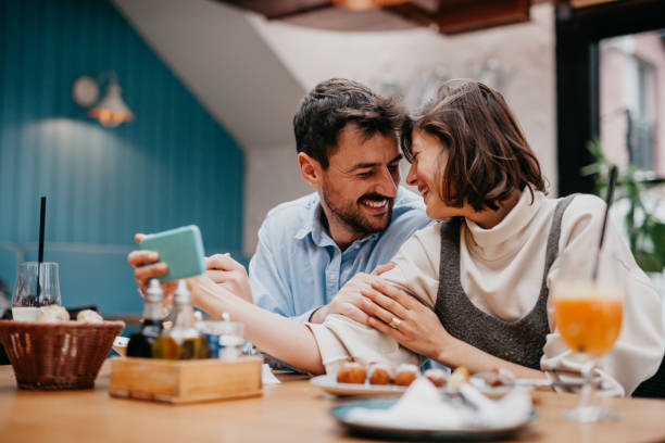 Couple in Restaurant having a video call stock photo