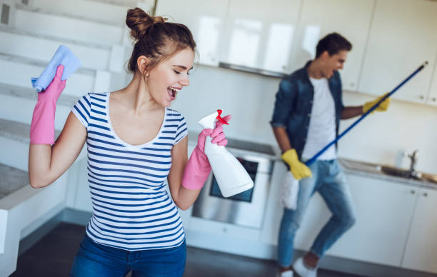 Couple is doing cleaning at home. stock photo