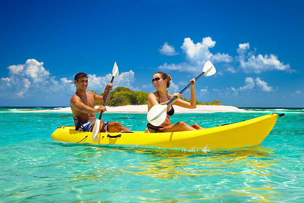 Pareja de paseo en kayak por una isla tropical del Caribe.