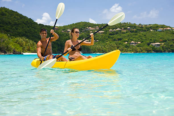 young couple kayaking in crystal clear turquoise water in the Virgin Islandsview images from the same series: