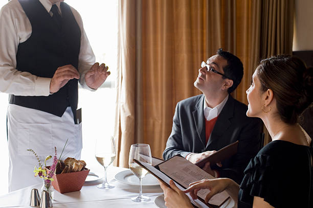 Couple listening to waiter.   waiter taking order stock pictures, royalty-free photos & images