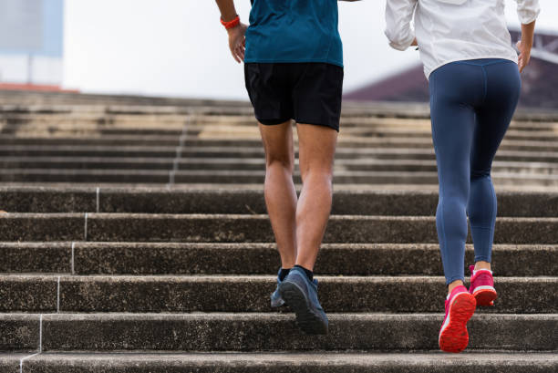 A couple of Asians are exercising and jogging up the stairs. stock photo