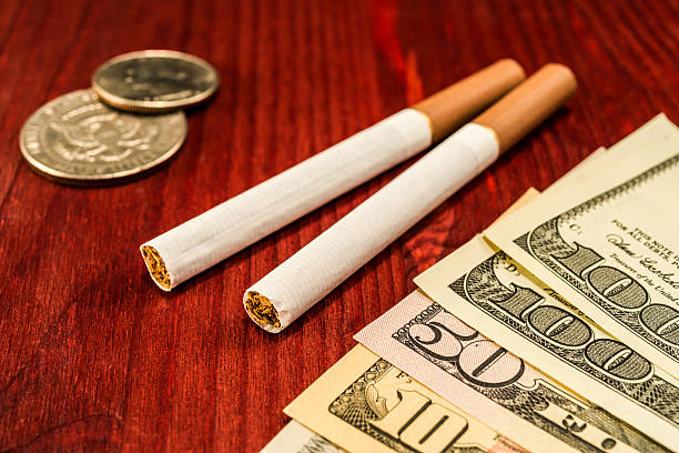 Couple of cigarettes with brown filters and a several dollar bills...
