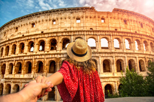 Couple of tourist on vacation in front of Colosseum Rome Italy stock photo