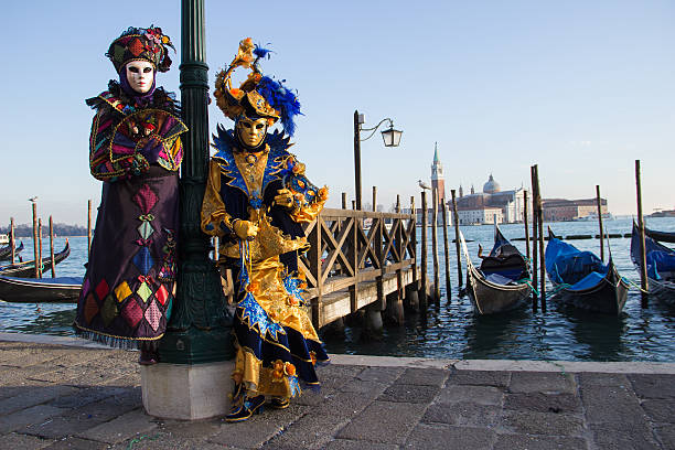 Couple of Venetian Masks on Venice Carnival with Gondolas stock photo