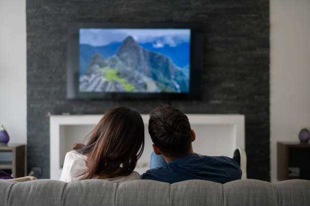 Couple on a romantic date at home watching a movie stock photo