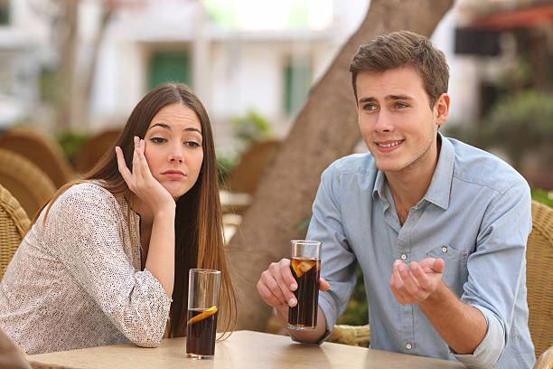 Couple rejection of a woman in her first date Man and woman dating in a restaurant terrace but she is boring while he speaks bad date stock pictures, royalty-free photos & images