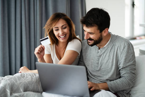 Couple shopping online with laptop and credit card. stock photo stock photo