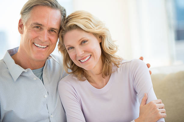 Couple Smiling Together At Home stock photo