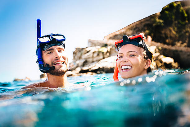 Couple Snorkeling Couple snorkeling on holiday woman snorkeling stock pictures, royalty-free photos & images