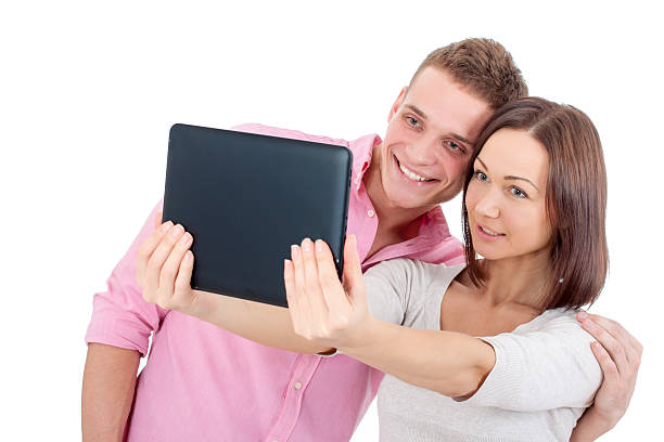 Couple taking a selfie ot a tablet PC. stock photo