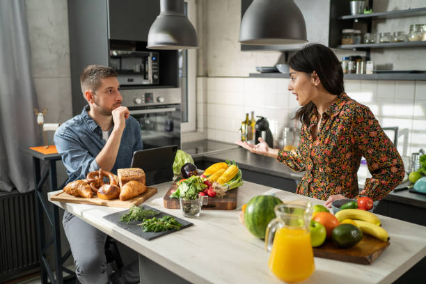 Couple talking in kitchen stock photo