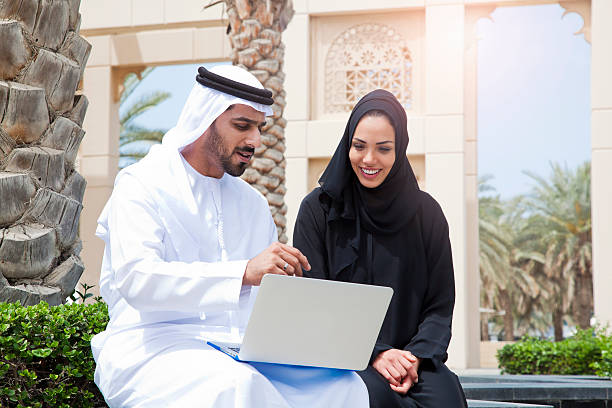 Couple Using Digital Tablet in Dubai. stock photo