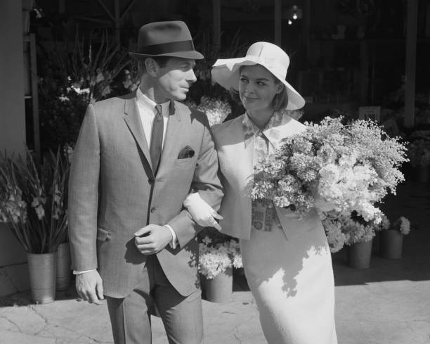 Couple walking together with bouquet near flower shop  1964 stock pictures, royalty-free photos & images