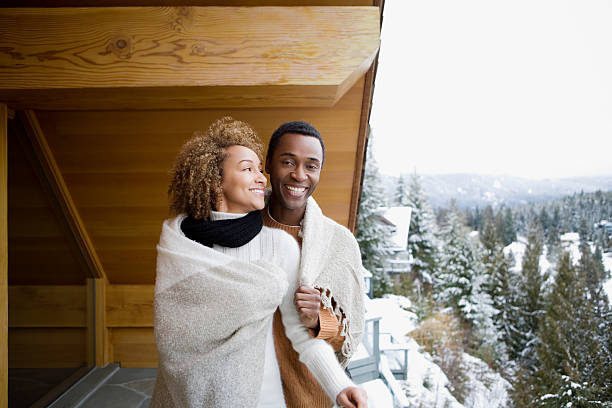couple wearing a blanket - happy couple cold stockfoto's en -beelden