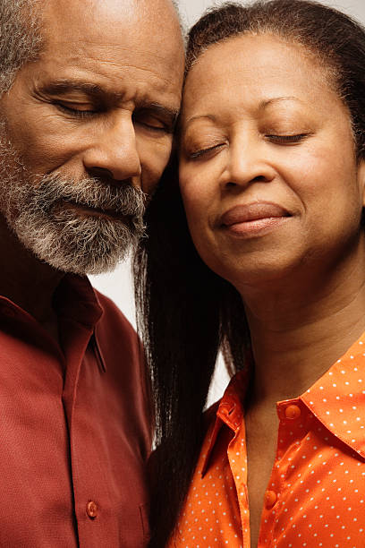 Couple with eyes closed, smiling, close-up Couple with eyes closed, smiling, close-up old black couple in love stock pictures, royalty-free photos & images