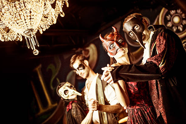 couples at the masquerade ball - kostuum stockfoto's en -beelden