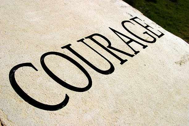 Courage written in a large font in all capital letters stock photo