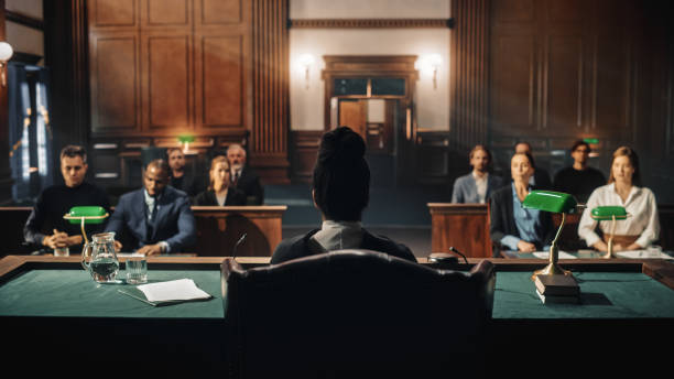 Court of Law Trial: Female Judge and and Jury Sit, Start of a Civil Case Hearing. Proceedings in Motion to Rule Out a Sentence. Defendant is Not Convicted nor Not Guilty. stock photo